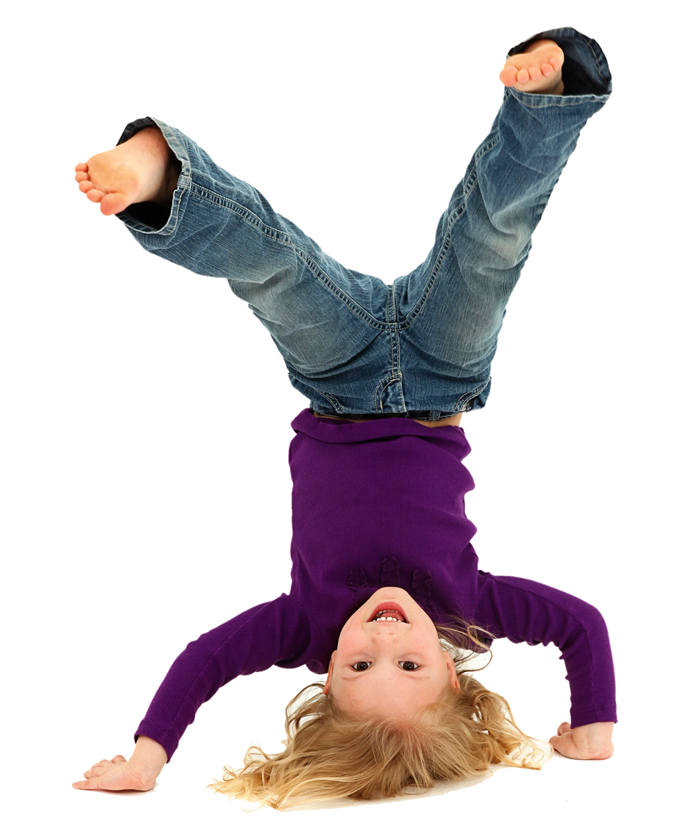 Child doing a headstand and smiling