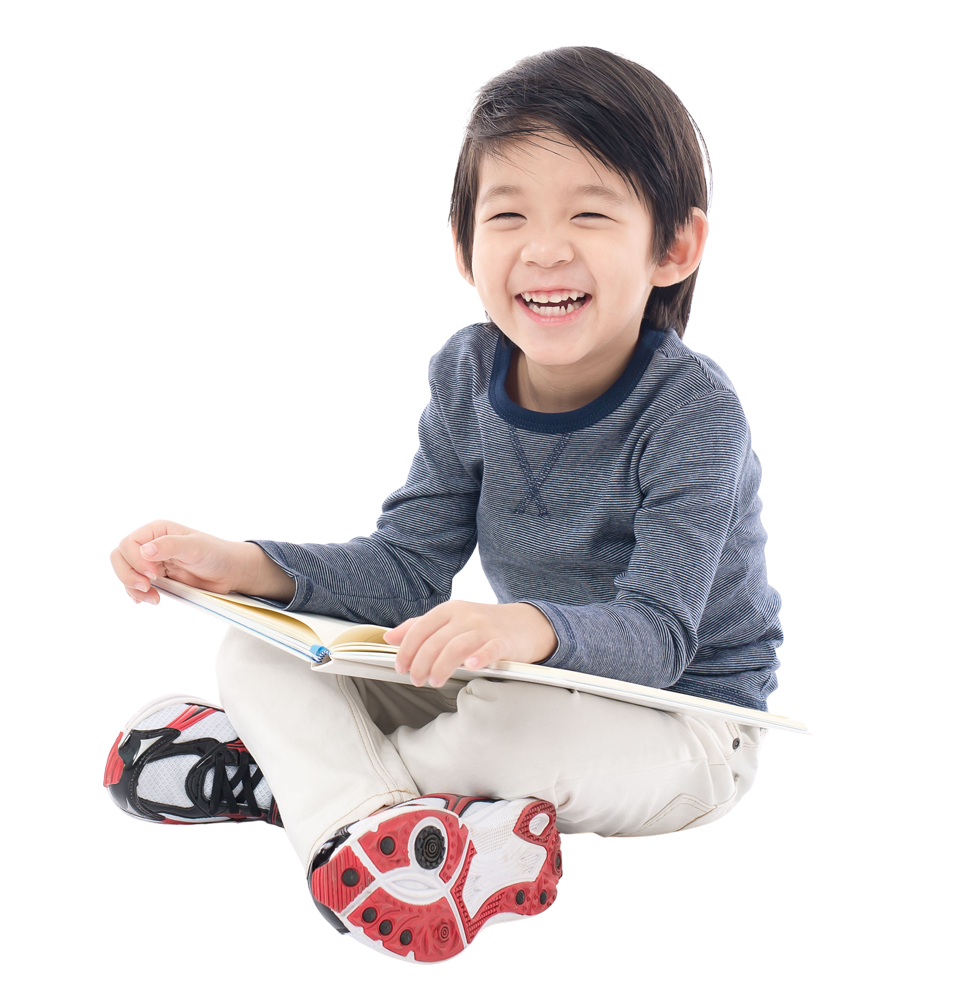 Young boy smiling with a book